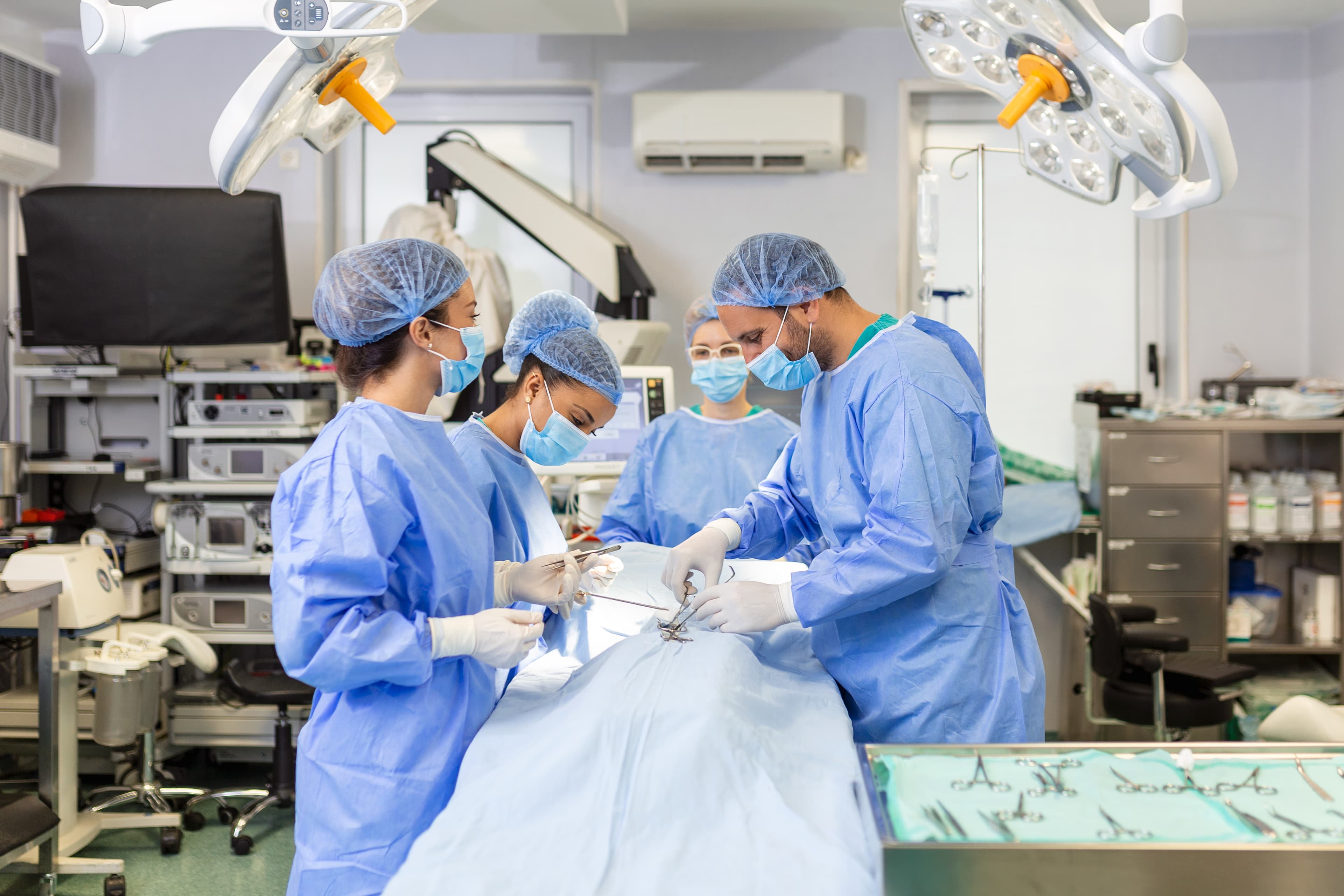 A surgical team operating under theatre lights